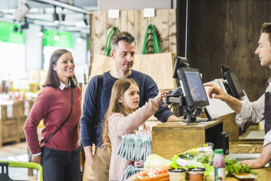 Bilde av jente som betaler med eget bankkort i butikken